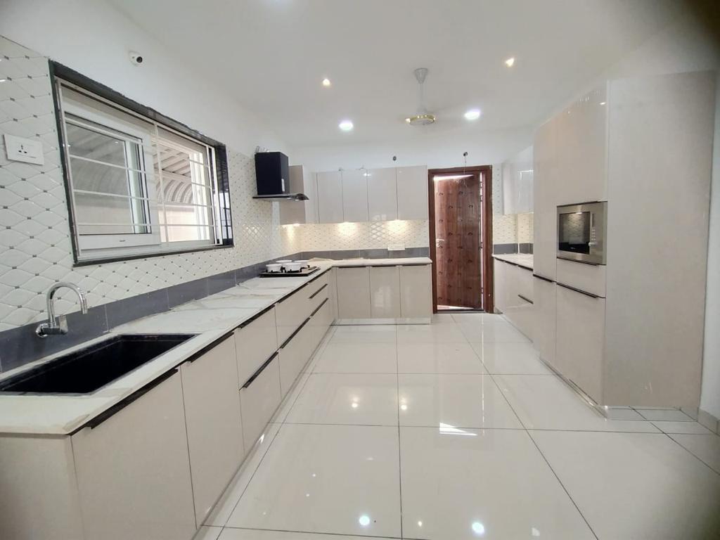 All-White Modular Kitchen with Island, Kanpur